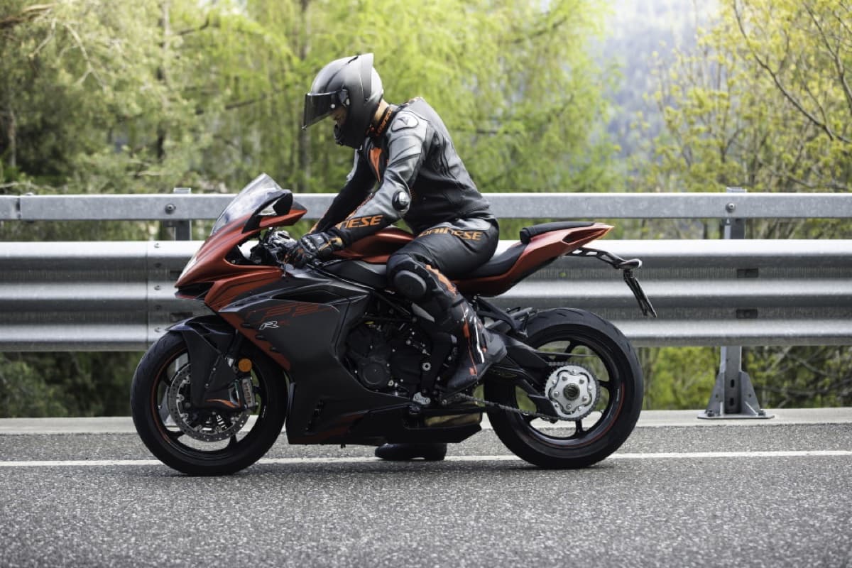 Rider wearing an AGV carbon fibre helmet on an MV Agusta sportbike on a scenic road