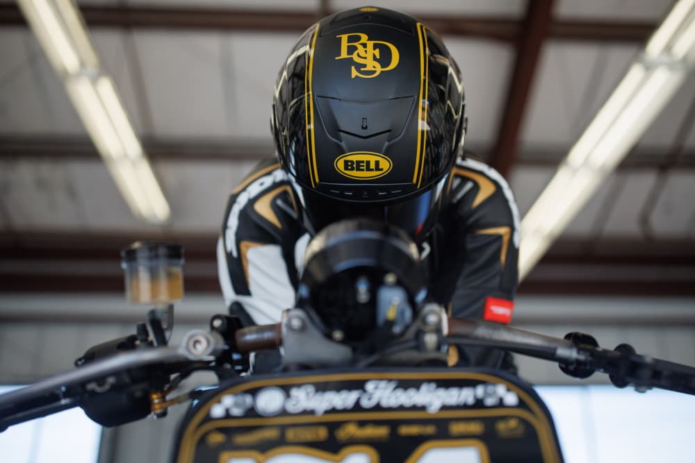 Motorcycle rider wearing a full face safety-rated helmet at the track