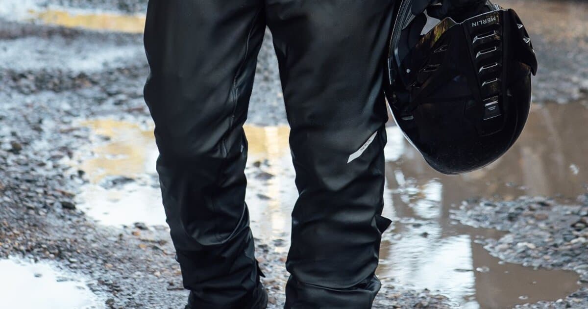Waterproof motorcycle pants laid out showing CE armour and laminated membrane construction